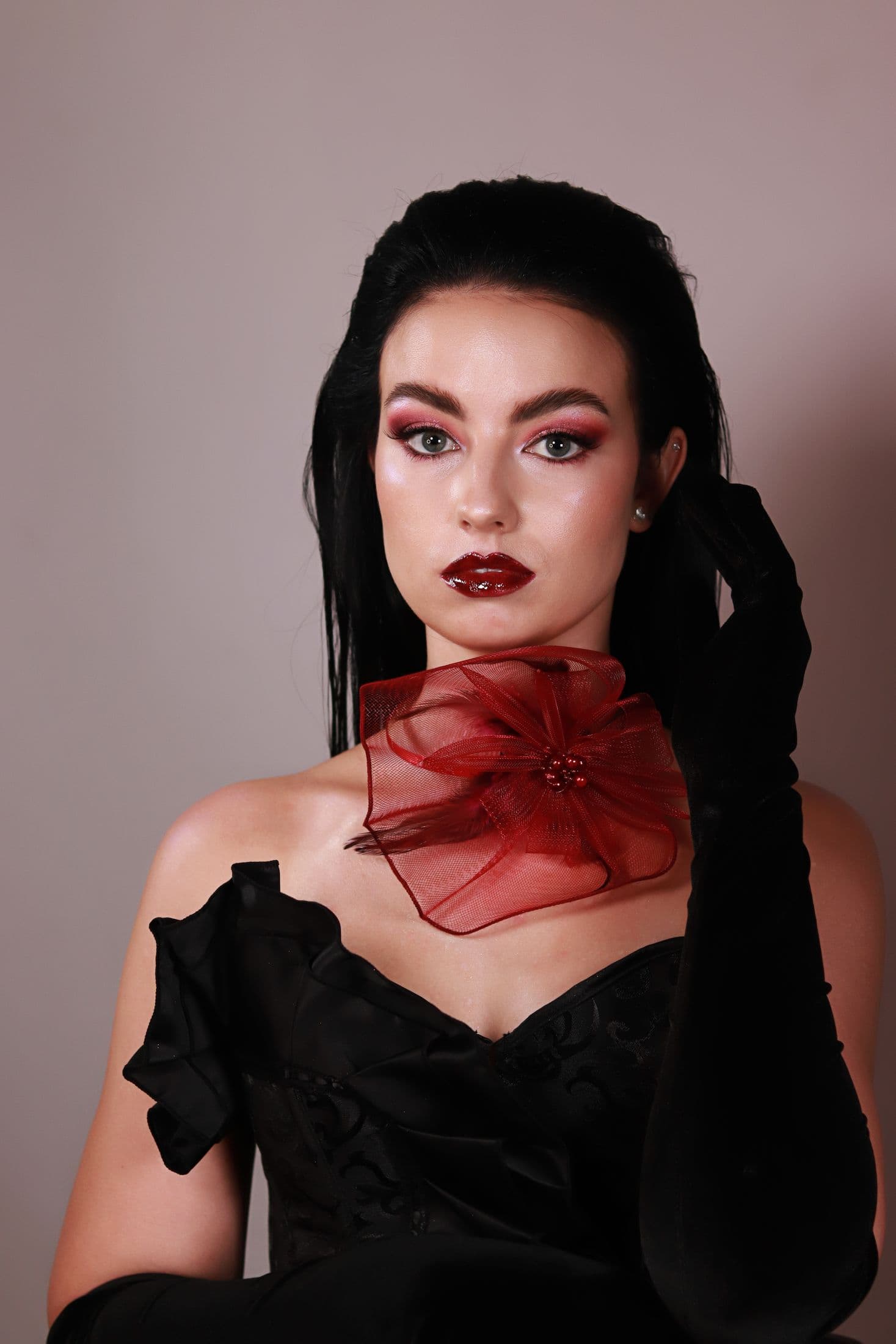 Evening beauty portrait with berry lips, pink eyes and black satin gloves